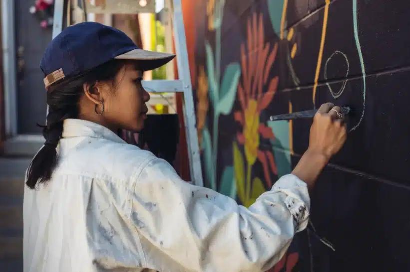 A girl painting a mural