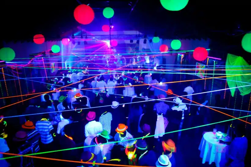 A glow-in-the-dark party with several people dancing