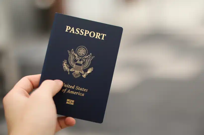 A hand holding a US Passport 